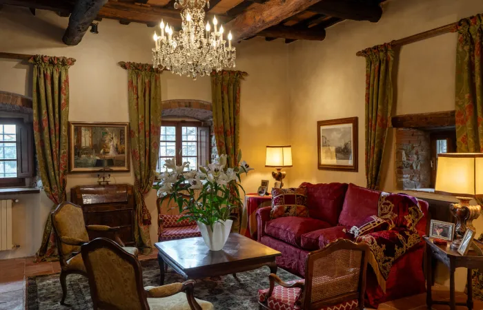 Hand-hewn beams and terracotta floors paired with thoughtful antique details.