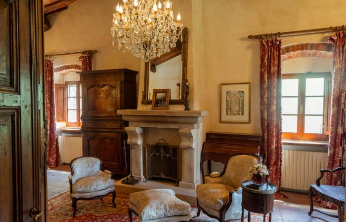 Antique chandeliers and a fireplace add charm and warmth.