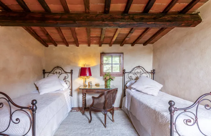 Tower Bedroom with twin beds, a writing desk and castle views.