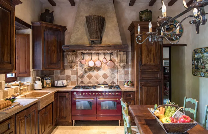 Modern kitchen with six-burner range, double ovens, full fridge and dishwasher.