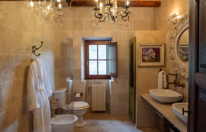 En-suite bath with walk-in shower with chandelier lighting.