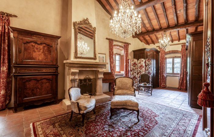 Antique chandeliers and a fireplace add charm and warmth.