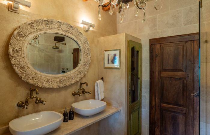 En-suite bath with walk-in shower with chandelier lighting.