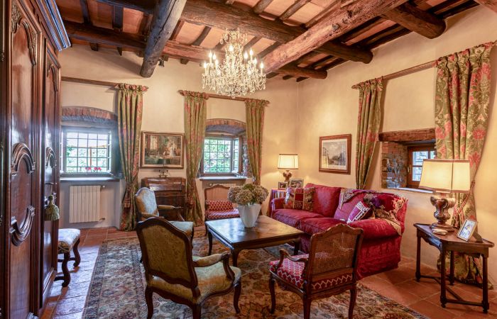 Hand-hewn beams and terracotta floors paired with thoughtful antique details.