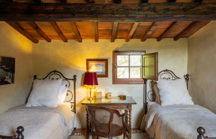 Tower Bedroom with twin beds, a writing desk and castle views.